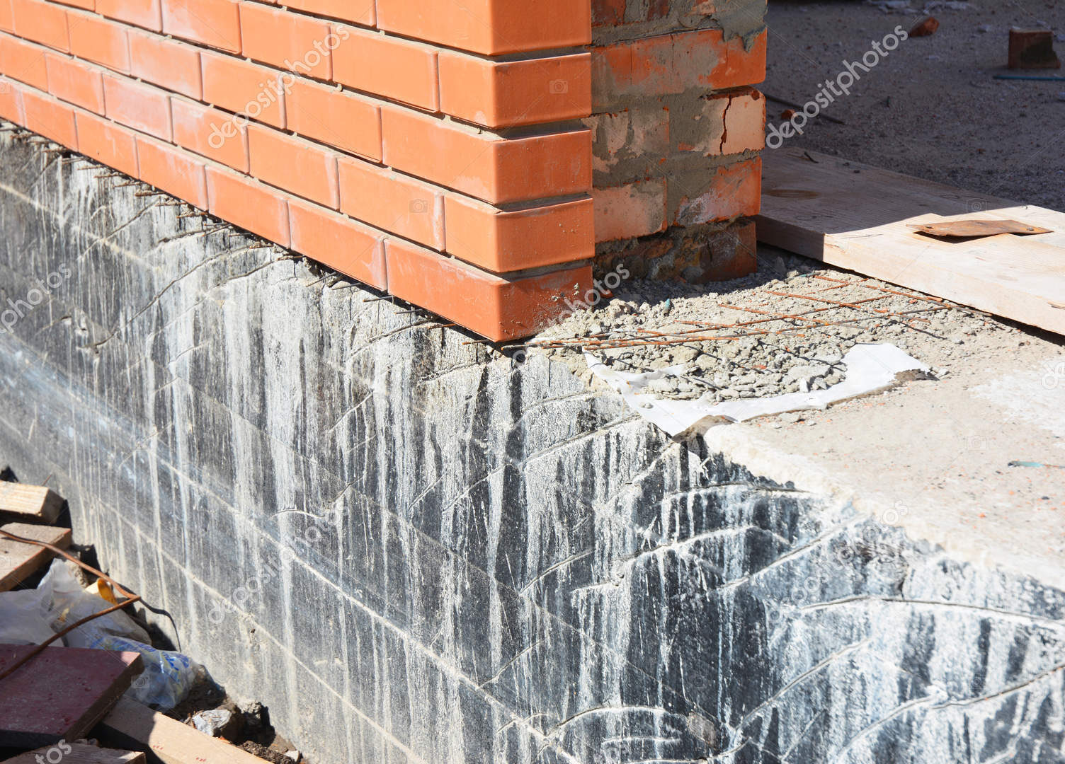 Foundation Waterproofing and Damp proofing Coatings. Waterproofing house foundation with bitumen spray on tar
